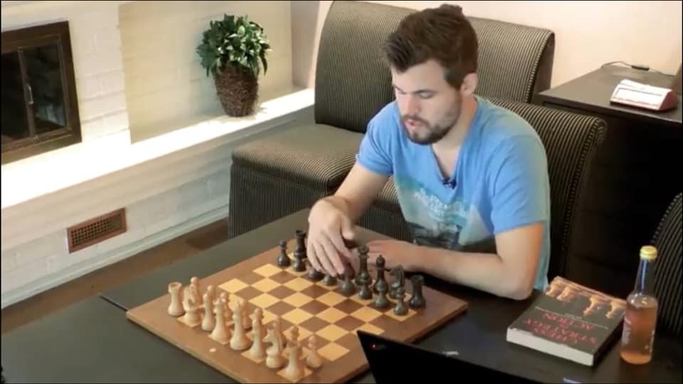 Magnus Carlsen, chessboard, chess book